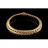 Property of a lady - an 18ct yellow gold flat curb link bracelet, 7.75ins. (19.7cms.) long.