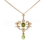 An Edwardian 15ct yellow gold peridot & seed pearl pendant on 15ct yellow gold chain necklace, the
