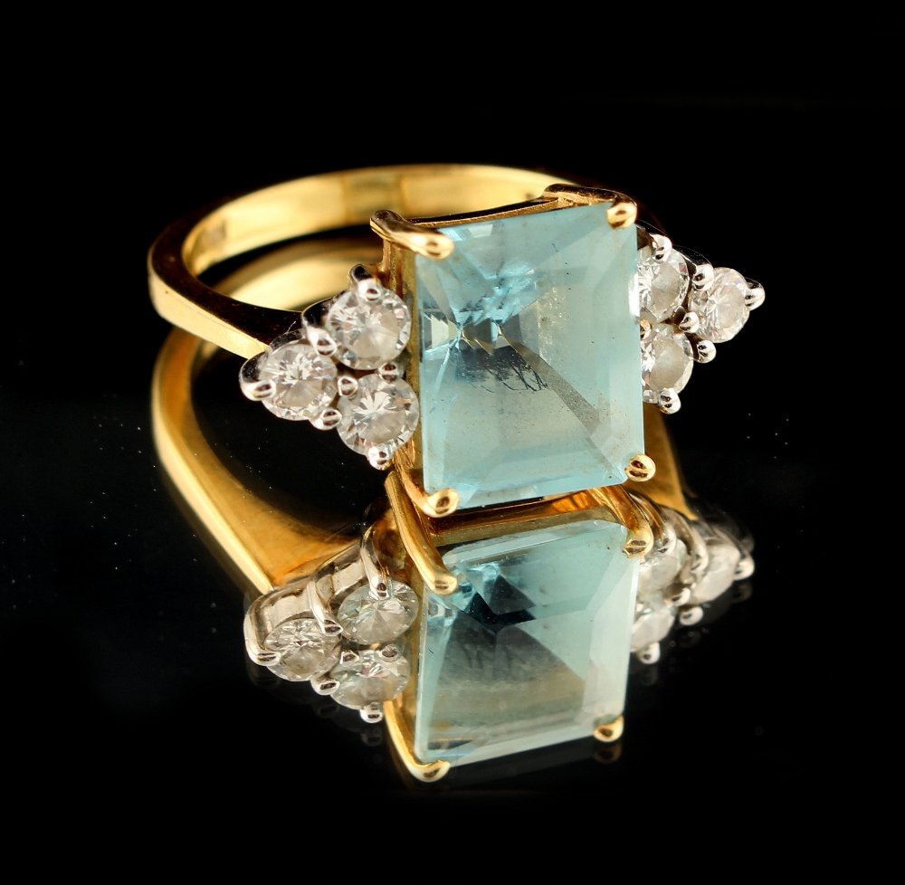 Property of a lady - an 18ct yellow gold aquamarine & diamond ring, the rectangular cut aquamarine