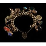 Property of a lady - a 9ct gold charm bracelet hung with various charms, intaglio seals & fobs,