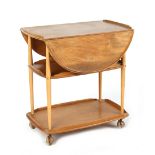 Property of a lady - an Ercol light elm three tier drop-leaf trolley, 29ins. (73.5cms.) long.