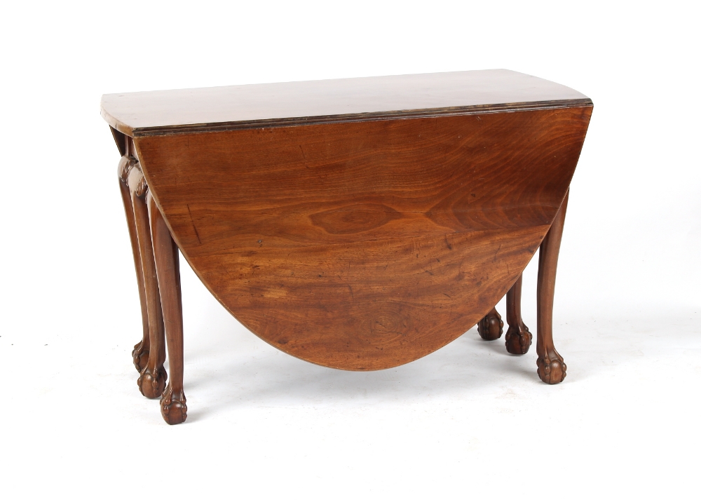 An 18th century George III Irish mahogany oval topped drop-leaf dining table with six carved