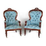 A pair of 19th century carved mahogany & blue floral button upholstered armchairs, with turned &