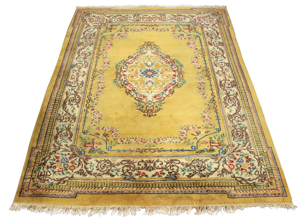 Property of a gentleman - an Indian hand knotted wool carpet with pale yellow ground, 143 by 108ins.