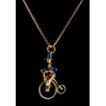 Property of a lady - an 18ct yellow gold & blue enamel figure of a gentleman riding a