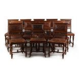 A set of twelve late 19th century French walnut & embossed leather upholstered dining chairs (12).