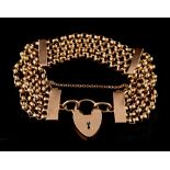 Property of a lady - a 9ct rose gold belcher chain bracelet with heart shaped padlock clasp, with