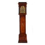 An early 18th century walnut cased 8-day striking longcase clock, the arched brass dial with