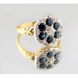 An unmarked yellow gold sapphire & diamond cluster ring, the six round cut sapphires weighing an