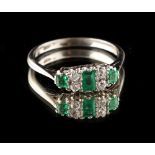 An unmarked white gold emerald & diamond ring, set with a rectangular cut emerald & two square cut