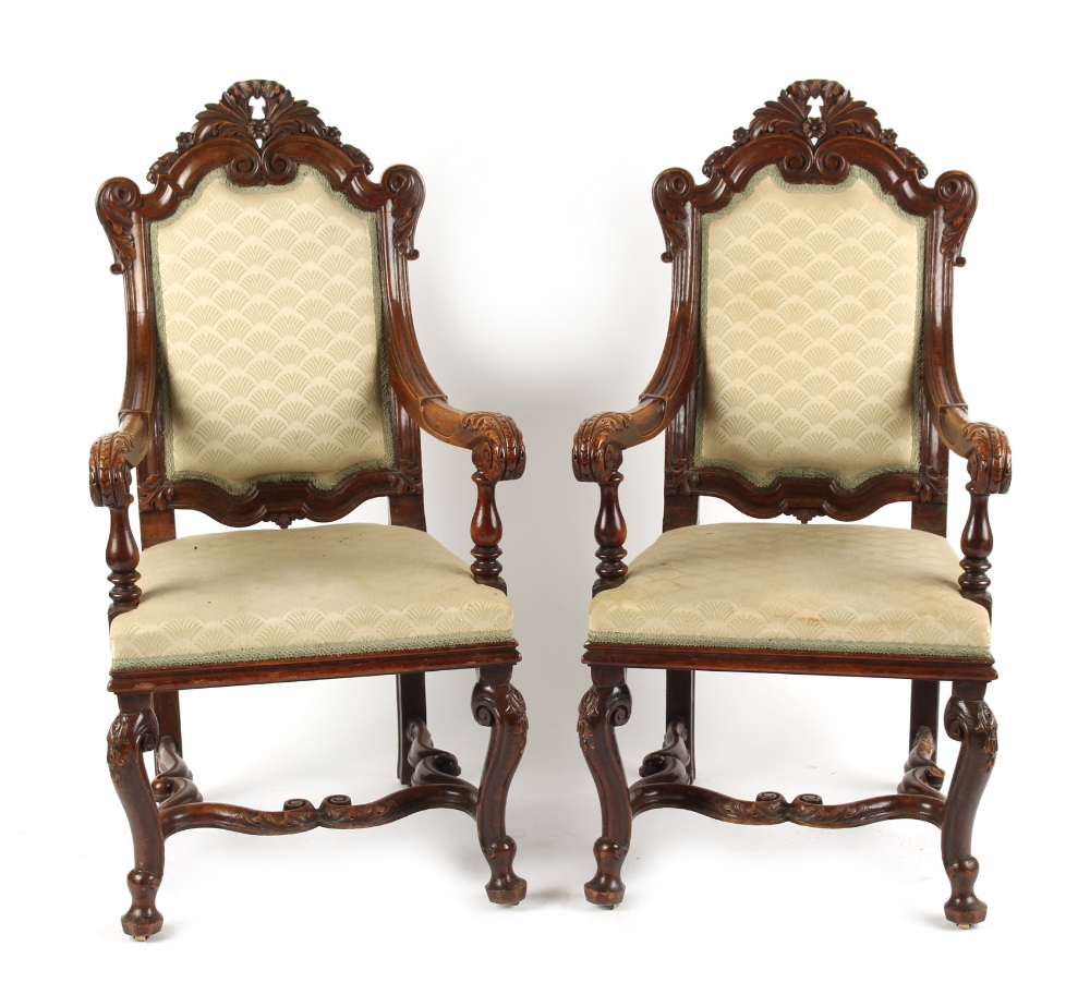 A pair of late 19th century carved oak & beige upholstered open armchairs, with cabriole legs &