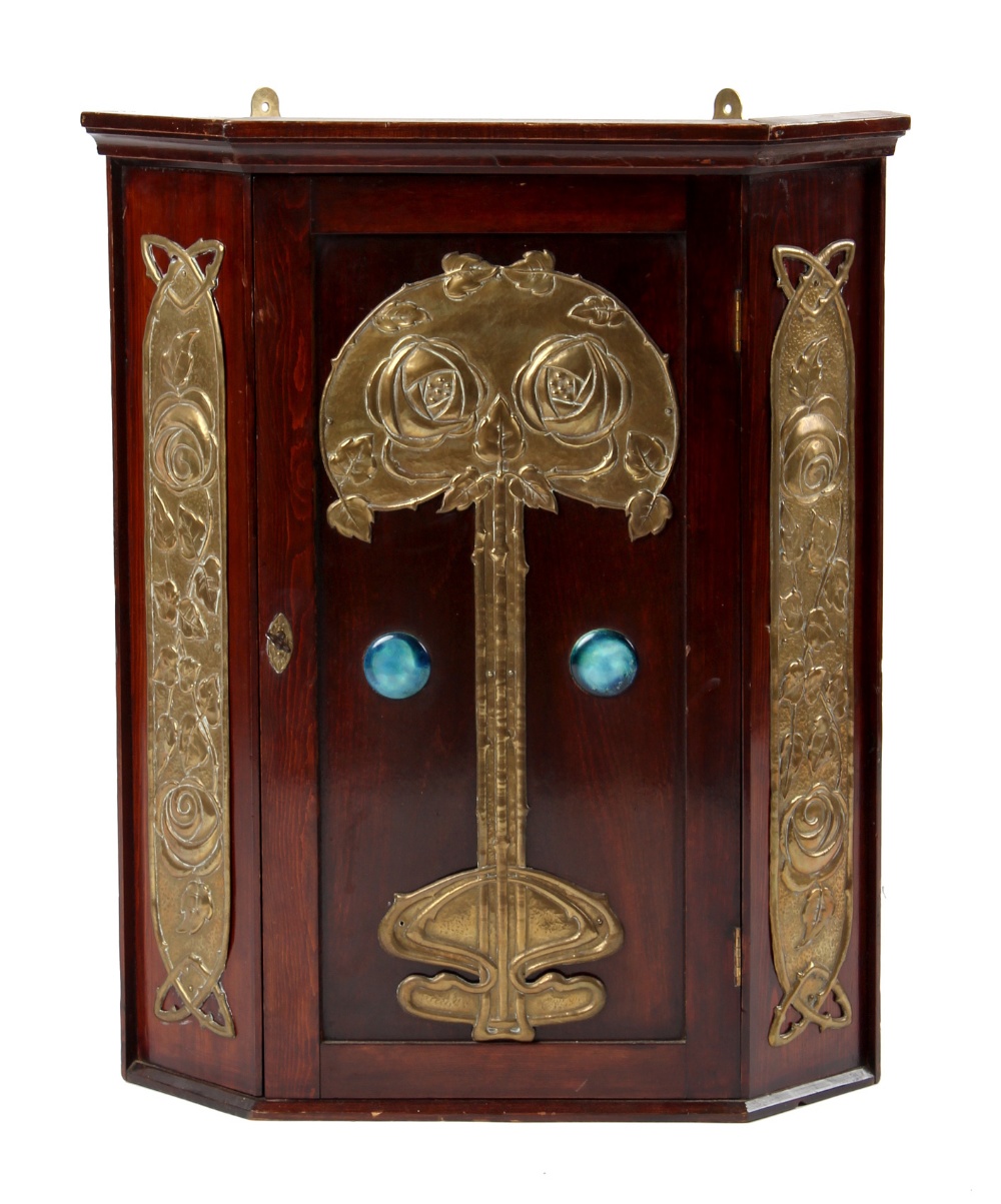 Property of a gentleman - an Arts & Crafts embossed brass mounted corner wall cabinet with Ruskin