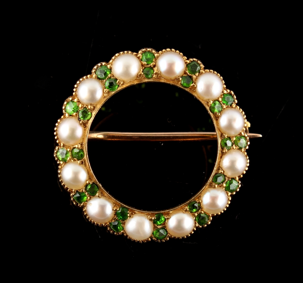 A late Victorian unmarked yellow gold demantoid garnet & seed pearl circular hoop brooch,