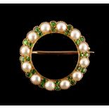 A late Victorian unmarked yellow gold demantoid garnet & seed pearl circular hoop brooch,