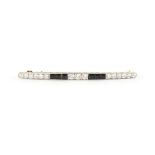 An Art Deco diamond & dark red stone (probably garnet) bar brooch, the estimated total diamond