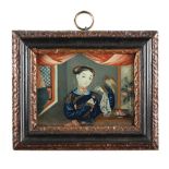 A small well painted Chinese reverse mirror painting depicting a lady feeding a bird, 18th