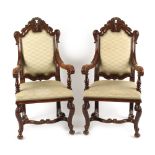 A pair of late 19th century carved oak & beige upholstered open armchairs, with cabriole legs &