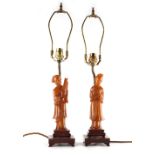 Property of a lady - a pair of Chinese carved amber figures of ladies, mounted as table lamps, the
