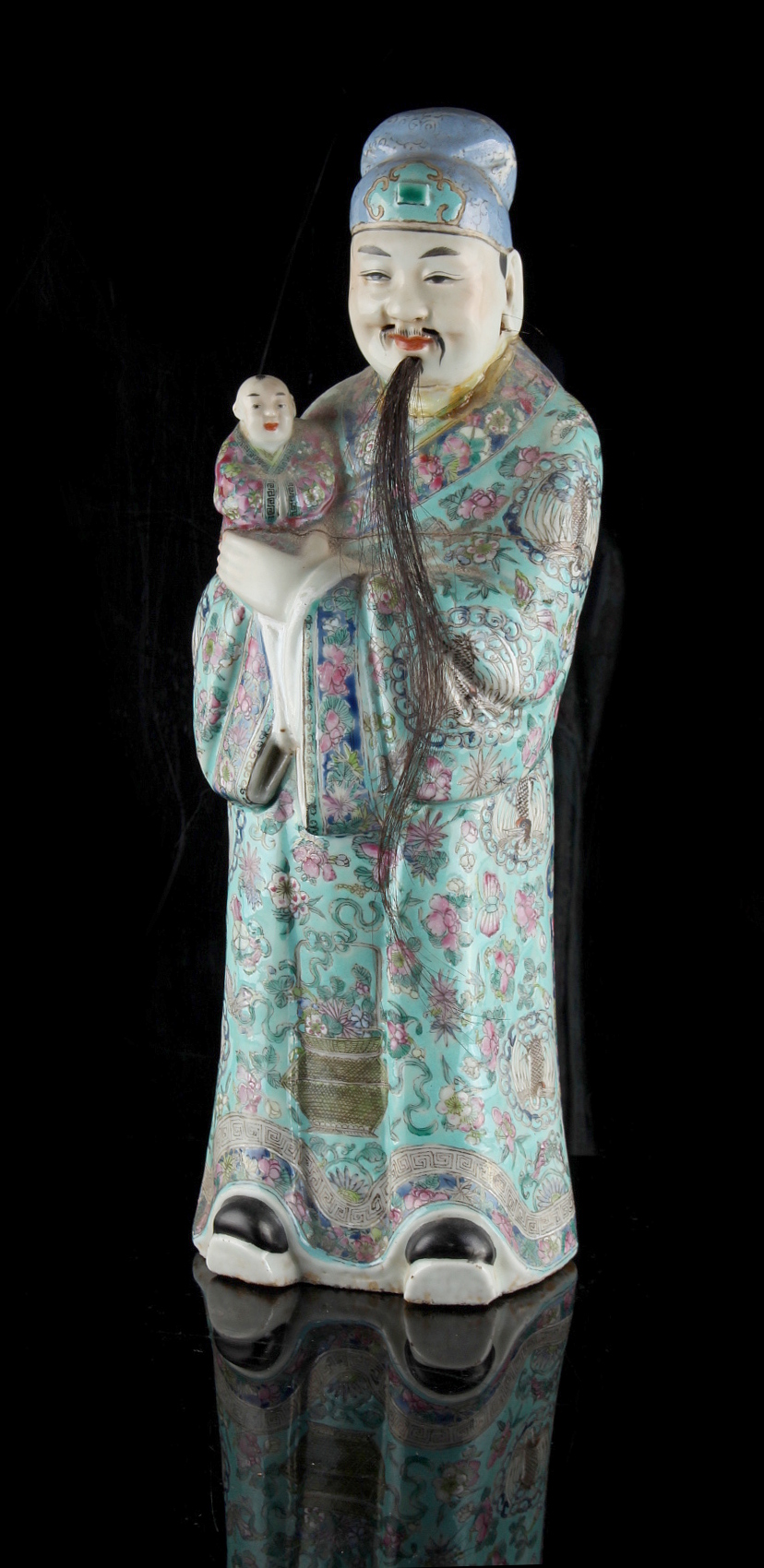 Property of a gentleman - a late 19th century Chinese famille rose figure of a mandarin holding a