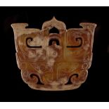 A Chinese carved jade Taotie mask plaque or pendant, 2.45ins. (6.2cms.) wide.
