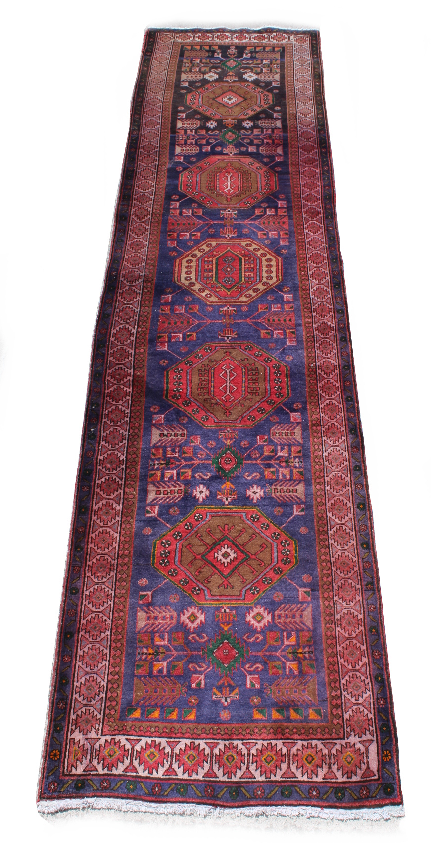 An Esari woollen hand-made carpet with blue ground, 160 by 42ins. (405 by 107cms.).