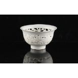A Chinese Dehua blanc de Chine pierced bowl, 18th century, 3.45ins. (8.8cms.) diameter.