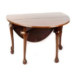 An 18th century George III Irish mahogany oval topped drop-leaf dining table with six carved