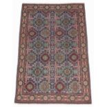 A Tabriz woollen hand-made rug with blue ground, 58 by 38ins. (147 by 97cms.).