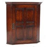 Property of a deceased estate - an early 20th century oak corner wall cabinet, 26.2ins. (66.5cms.)