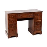 Property of a deceased estate - a reproduction oak desk, with nine drawers & turned handles,