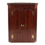 Property of a deceased estate - an 18th century George III flame mahogany panelled two-door corner