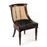 Property of a gentleman - an early 19th century Regency period mahogany & cane panelled bergere side