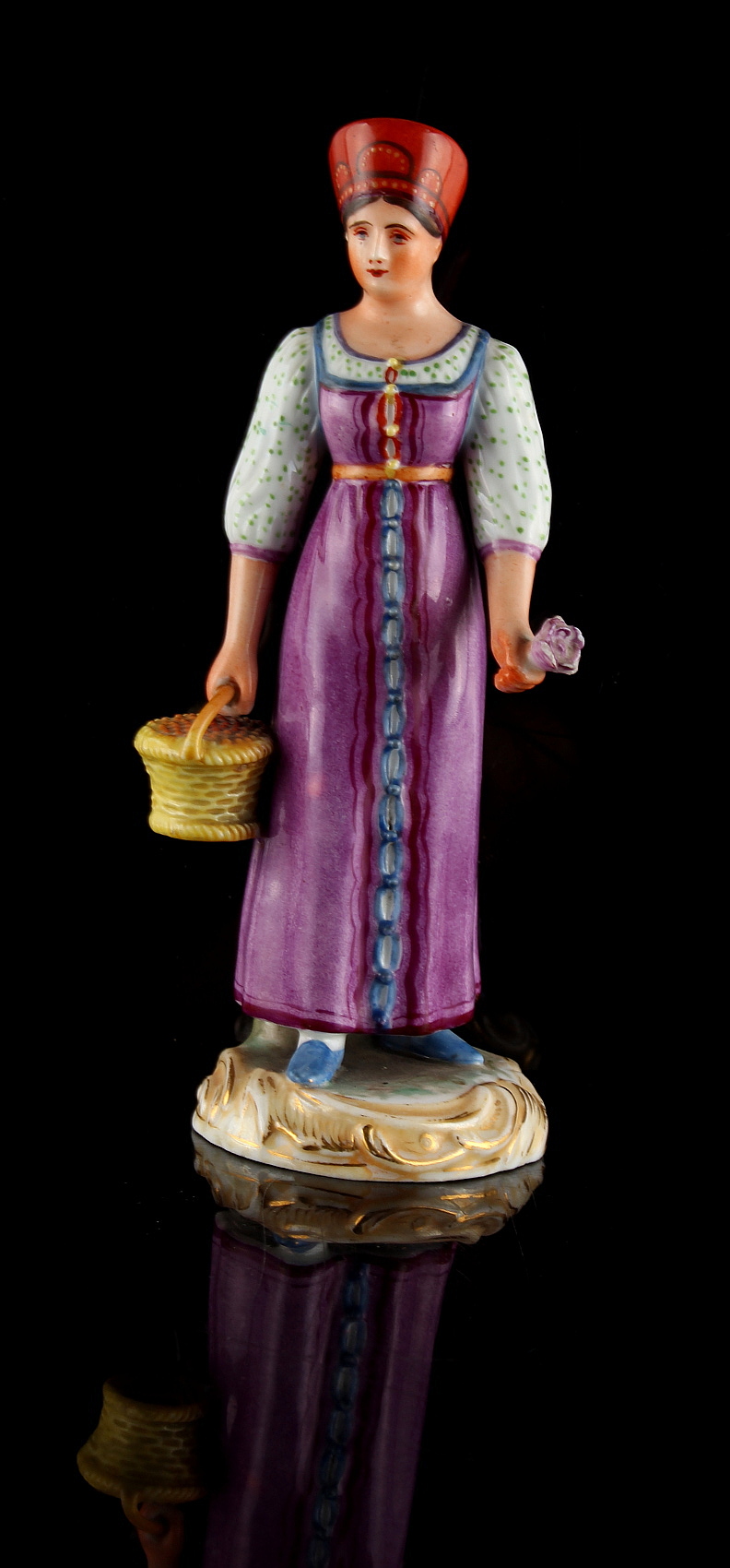 Property of a lady - a 19th century Russian Gardner figure of a lady in traditional dress,