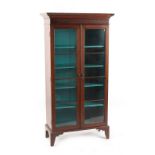 Property of a deceased estate - a early 19th century mahogany glazed two-door bookcase, with