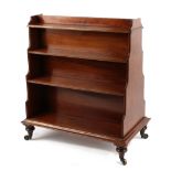 Property of a gentleman - a late Regency period mahogany double sided dwarf waterfall bookcase, with