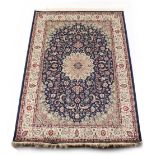 A Kashan style rug with blue ground, 79 by 55ins. (200 by 140cms.).