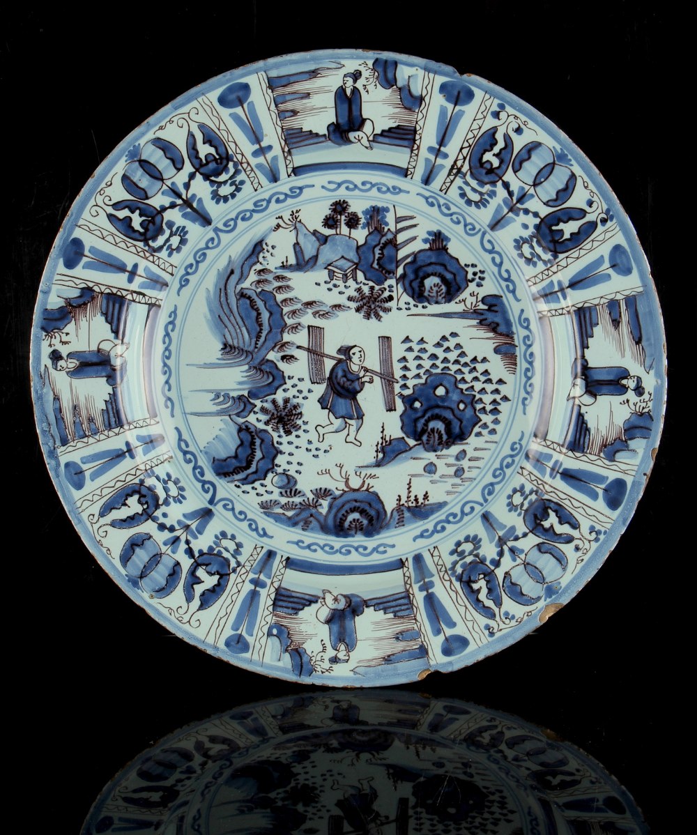 Property of a lady - an 18th century English delft charger or shallow dish, painted in blue &