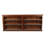 Property of a lady - an Edwardian oak dwarf open bookcase, the adjustable shelves with leather