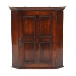 Property of a deceased estate - an early 20th century oak corner wall cabinet, 26.2ins. (66.5cms.)
