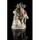 A Meissen bocage group, late 19th century, modelled as a lady playing a lute, with a companion