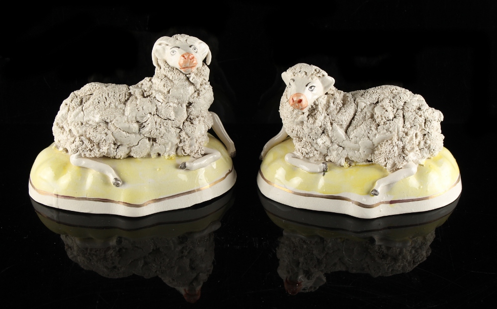 Property of a lady - a pair of 19th century Staffordshire porcelain models of a recumbent ram and