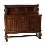 Property of a deceased estate - a reproduction carved oak sideboard with linenfold decorations,