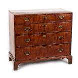 Property of a gentleman - a George II walnut caddy top chest of four long graduated drawers, with