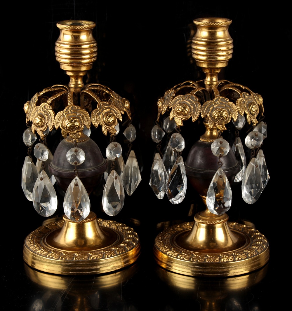 Property of a lady - a pair of late 19th century French ormolu or gilt brass candlestick table