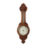 Property of a lady - a late Victorian carved oak cased aneroid barometer & thermometer, 33.25ins. (