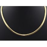 Property of a lady - a Portuguese high carat yellow gold link necklace set with a single round cut