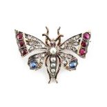 A 19th century multi gem set butterfly brooch, set with round cut rubies, round cut sapphires,