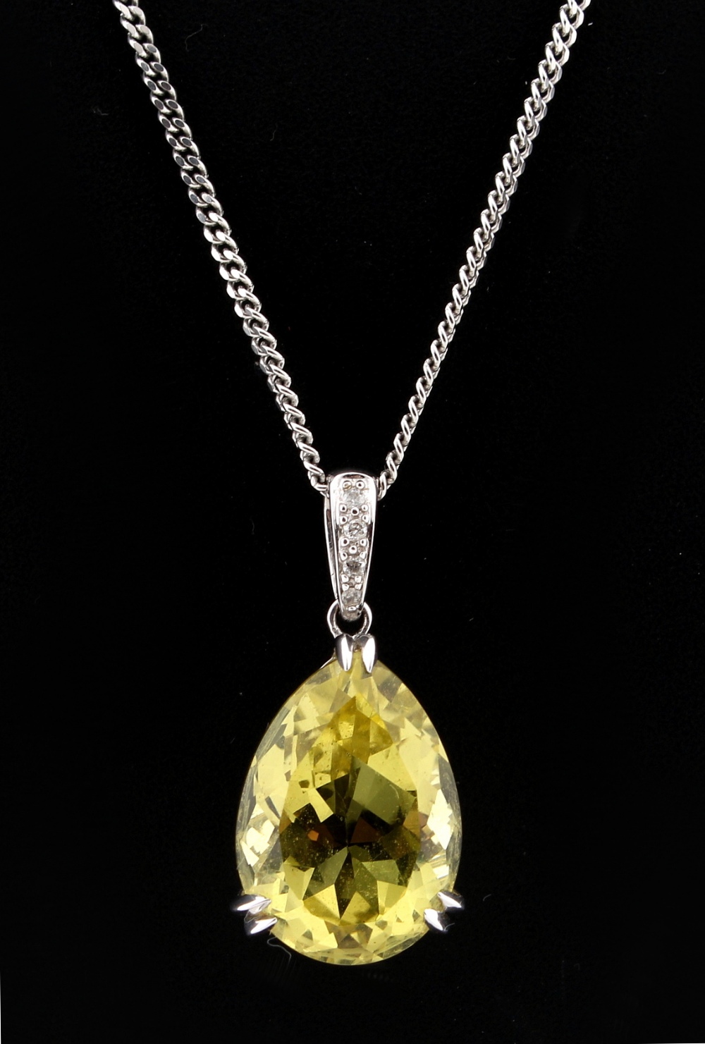 Property of a lady - a 14ct white gold cut pear shaped lemon quartz pendant with diamond set