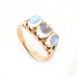 A yellow gold moonstone three stone ring, the oval moonstones weighing an estimated total of 2.52