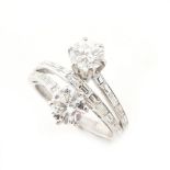 A good 18ct white gold diamond crossover ring, the two round brilliant cut diamonds weighing